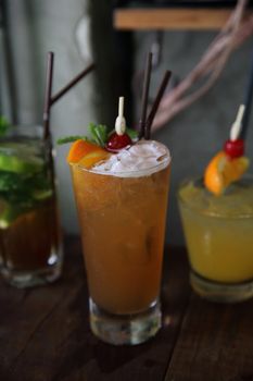 mai tai cocktail with orange cherry fruits on wood background