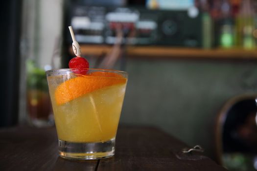 mai tai cocktail with orange cherry fruits on wood background