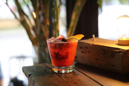 mai tai cocktail with orange cherry fruits on wood background