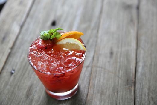 mai tai cocktail with orange cherry fruits on wood background