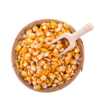 Corn seeds and wooden spoon isolated on a white background.