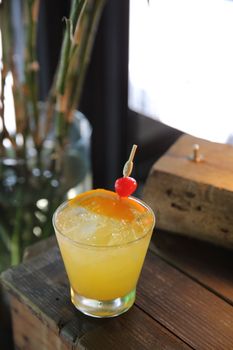 mai tai cocktail with orange cherry fruits on wood background