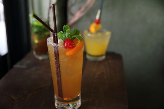 mai tai cocktail with orange cherry fruits on wood background
