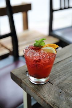 mai tai cocktail with orange cherry fruits on wood background