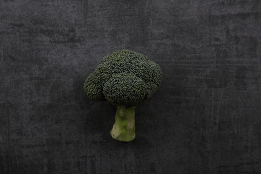 Vegetable broccoli isolated on dark rock background