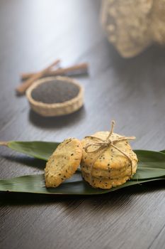 Sesame Cookies, sesame and milk on black wooden background.