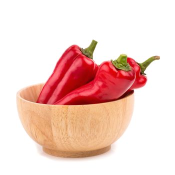 red chilli vegetable in Wooden bowl Isolated on white background.