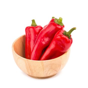 red chilli vegetable in Wooden bowl Isolated on white background.