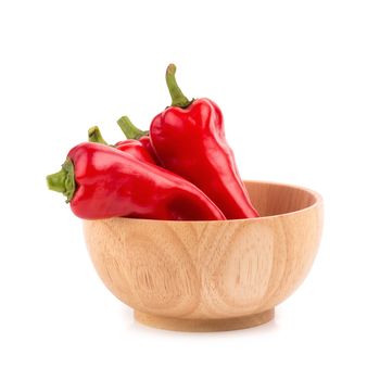 red chilli vegetable in Wooden bowl Isolated on white background.