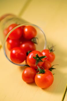 Fresh tomatoes Healthy food concept. on yellow table background.