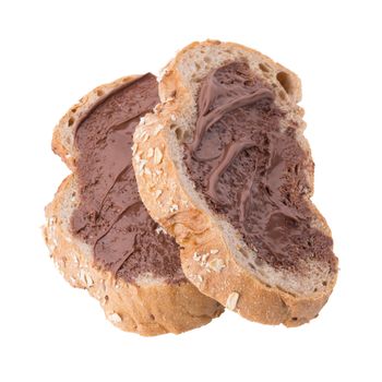 Chocolate creamy spread on brown whole wheat bread slice isolated on white background.