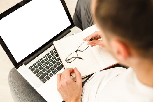 Cropped image of a young man working on his laptop, rear view of business man hands busy using laptop, young male student typing on computer sitting