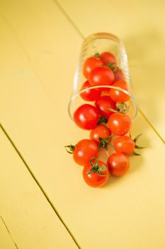Fresh tomatoes Healthy food concept. on yellow table background.