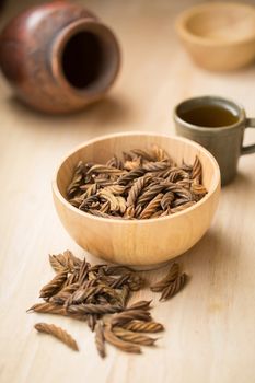 East Indian screw tree and Tea ,Thai herb for health on wooden background.