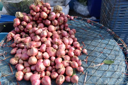 Shallot on a basket Sold in a rural market in Thailand.