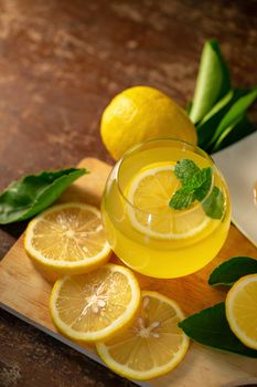 Lemon juice with honey on wooden table,  lemons and sage leaves.