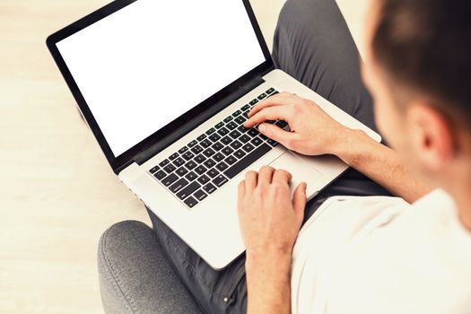 Cropped image of a young man working on his laptop, rear view of business man hands busy using laptop, young male student typing on computer sitting