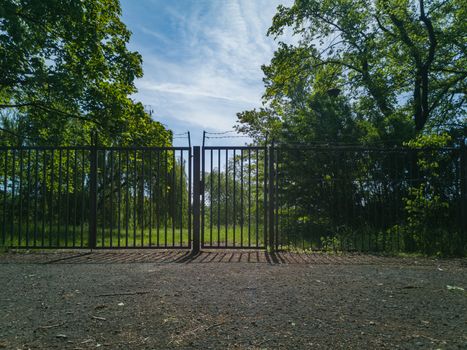 Fence with gateway with barbed wire on top