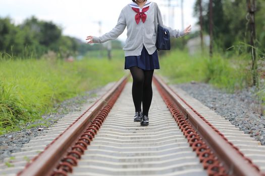 Portrait of Japanese school girl with countryside park