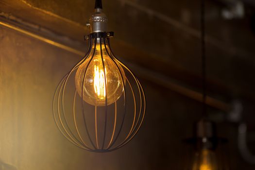 Decorative antique edison style light bulbs against brick wall background.