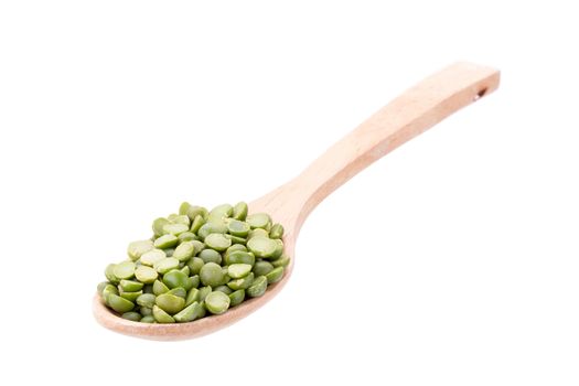 Split Green Peas on wooden spoon isolated on white background.