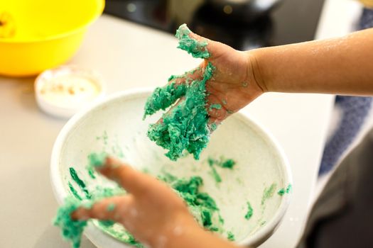 Little cute girl is cooking on kitchen. Having fun while making cakes and cookies