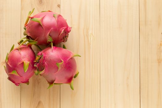 Tropical dragon fruit on wooden background. Top view.