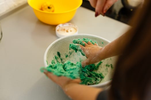 Little cute girl is cooking on kitchen. Having fun while making cakes and cookies. Smiling