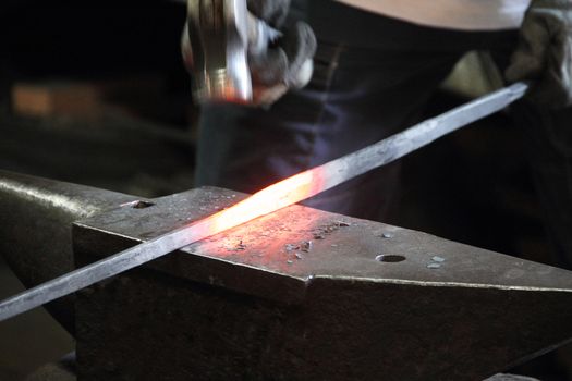 Blacksmith making sword in a forge of Toledo