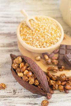 Corn kernels in wooden plates and popcorn with Caramel and chocolate cream on wooden table.