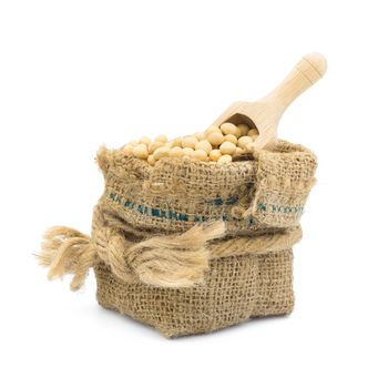 Soybean in burlap bag isolated on white background.