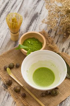 Set of matcha powder bowl, wooden spoon and whisk, green tea leaf, Organic Green Matcha Tea ceremony.