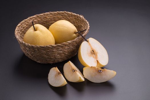 Chinese pear fruits on black background.