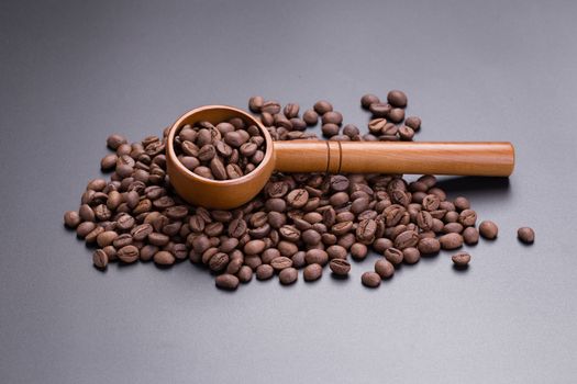 Coffee bean and spoon on a black background.