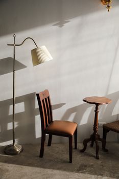 Wooden table and chairs with lamp on wall