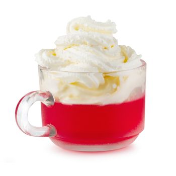 Strawberry jelly in a glass topping with cherries and whipped cream isolated on white background.