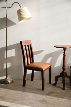 Wooden table and chairs with lamp on wall