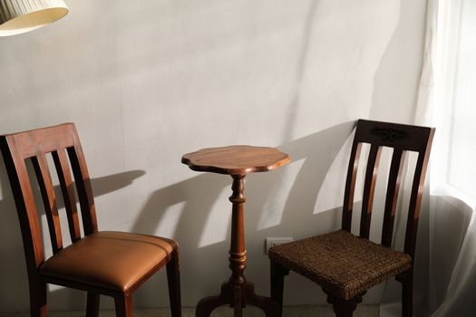 Wooden table and chairs with lamp on wall