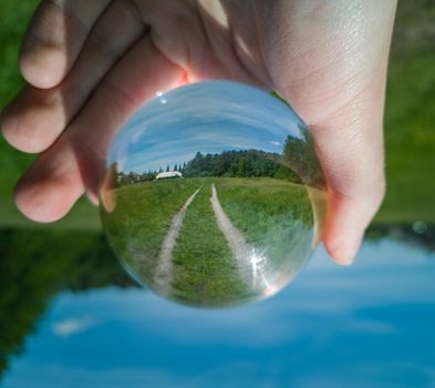 Landscape with Double path reflecting in crystal glass ball