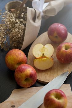 Red apples on black wooden table background. Still life.