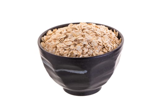 Oat in Black bowl isolated on a white background.