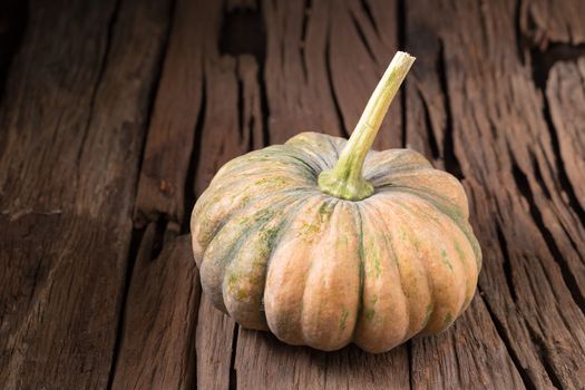 pumpkins on old wooden boards background Closeup.