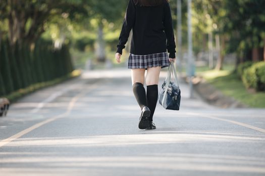 Portrait of asian japanese school girl costume walking at park outdoor film vintage style