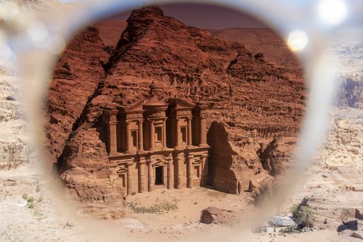 View on the monastery of Petra through the tainted glass of a sunglasses. Creative image.