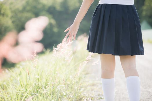 Portrait of asian japanese school girl costume looking at park outdoor film vintage style