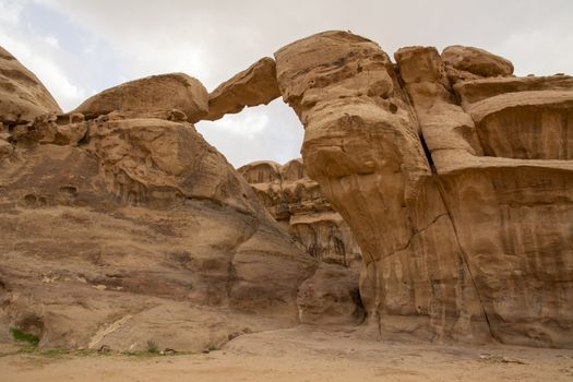 View on the Um Frouth natural Rock Bridge in Wadi Rum Desert, Jordan. Travel and Tourism in the Middle East.
