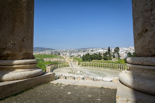 Greco-Roman ruins of Gerasa and the modern city of Jerash in the background. Oval Forum, Colonnaded Street and Cardo Maximus in clear view.