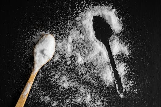 Salt powder on the back wooden background.