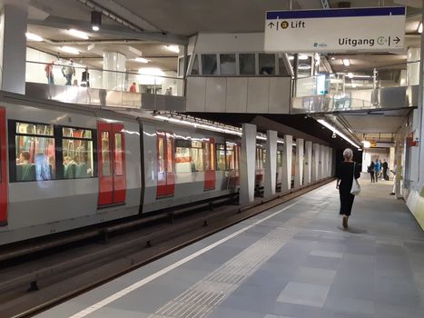 Rotterdam, Netherlands, September 2019: People waiting for the train in the subway of Rotterdam, ready to commute