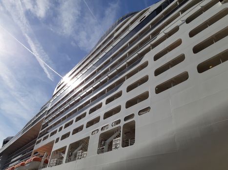 Side view of cruise ship on the blue sky background. Low angle view